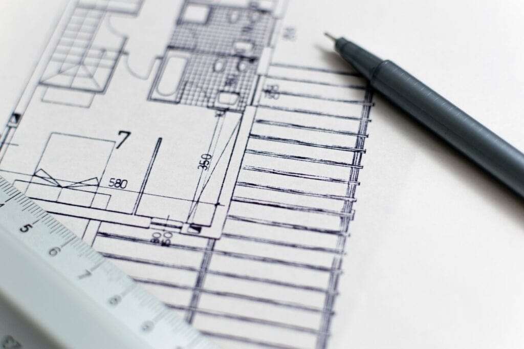 Blueprints/drawings with a rule and a pen