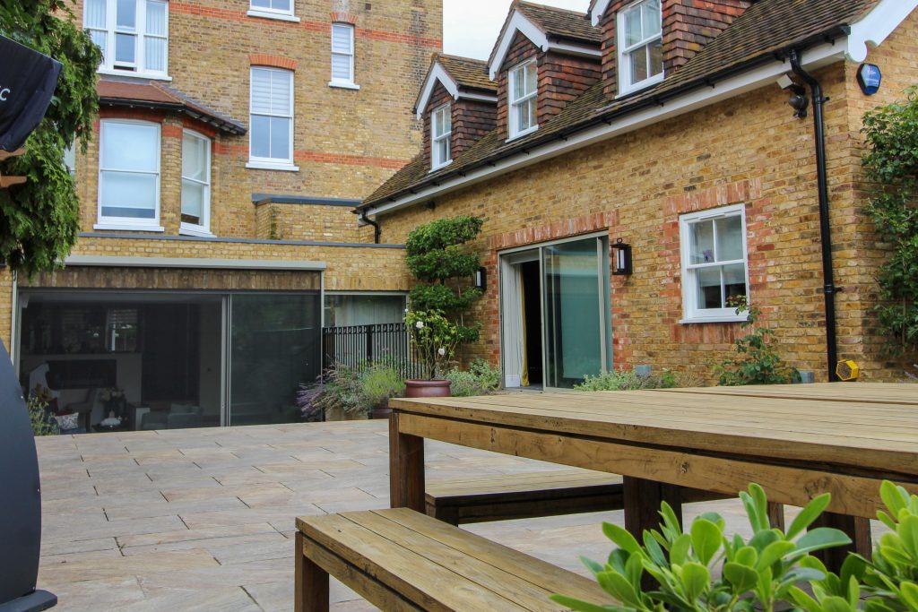 Outdoor seating on a patio outside a contemporary home