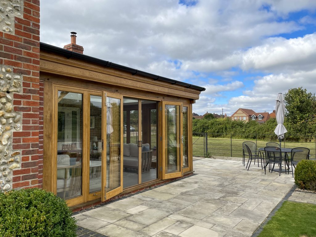 Exterior of a North Norfolk oak orangery with double fly screen doors